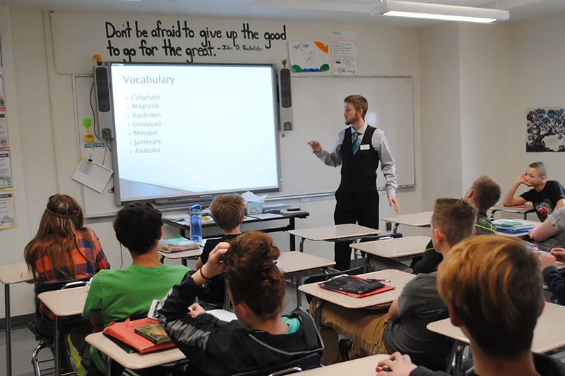 Houghton education major teaching in front of class during student teaching experience.