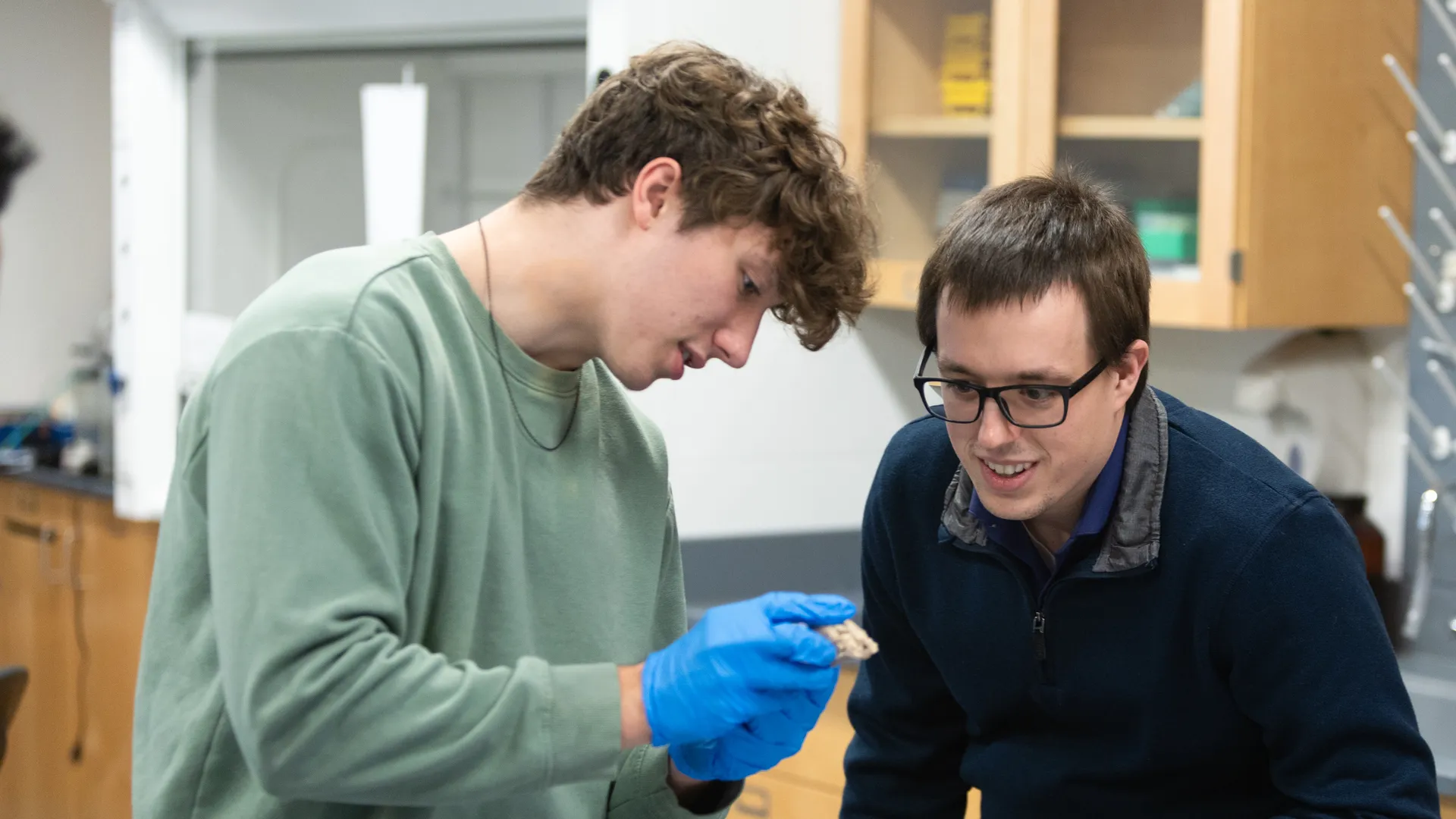Houghton biology student working with professor during dissection lab.