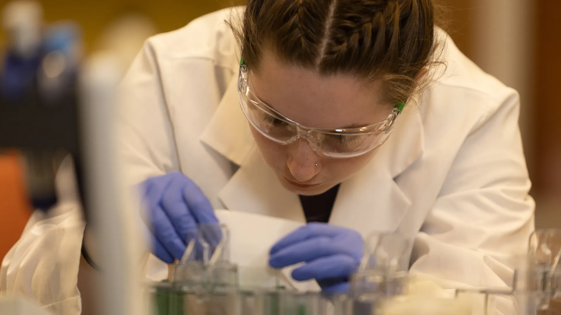 Houghton biochemistry student working in a lab at the Shannon Summer Research Institute.