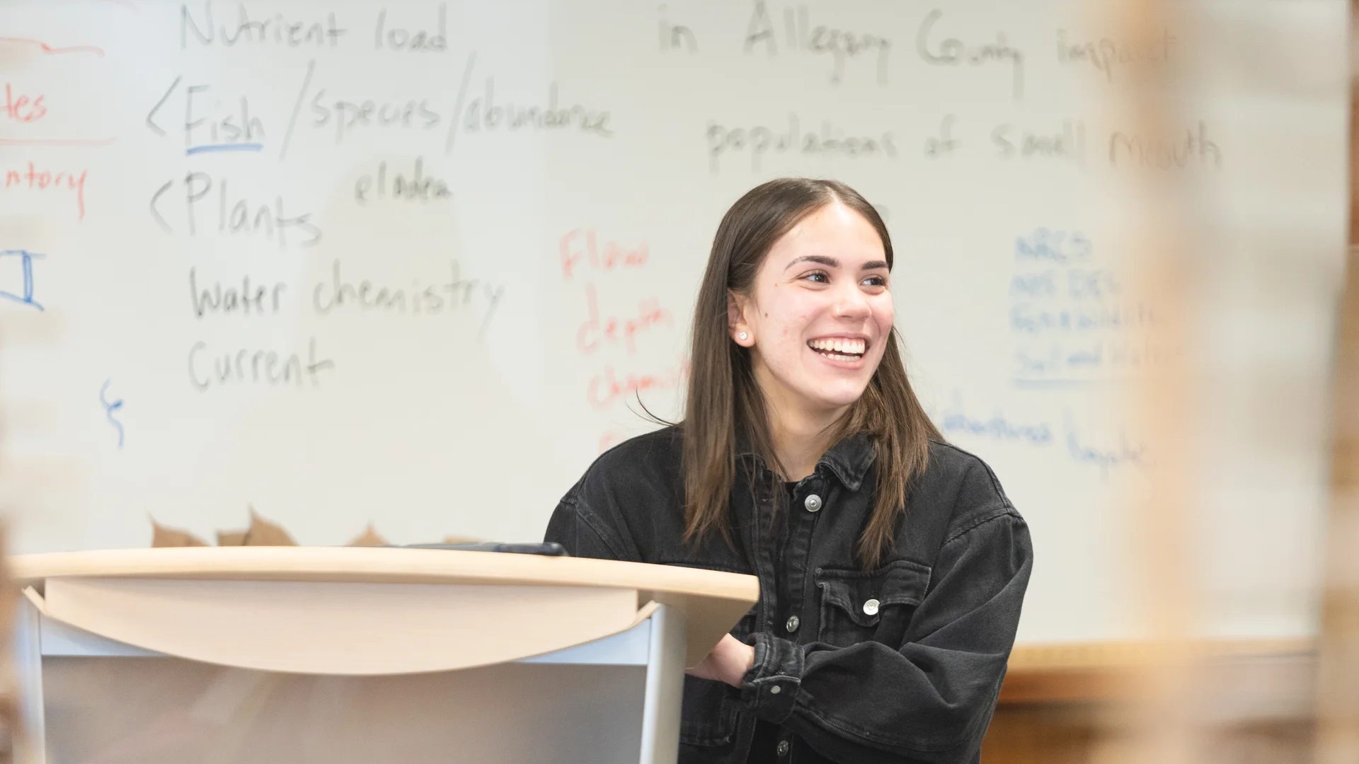 Houghton student standing at podium during biology lecture.