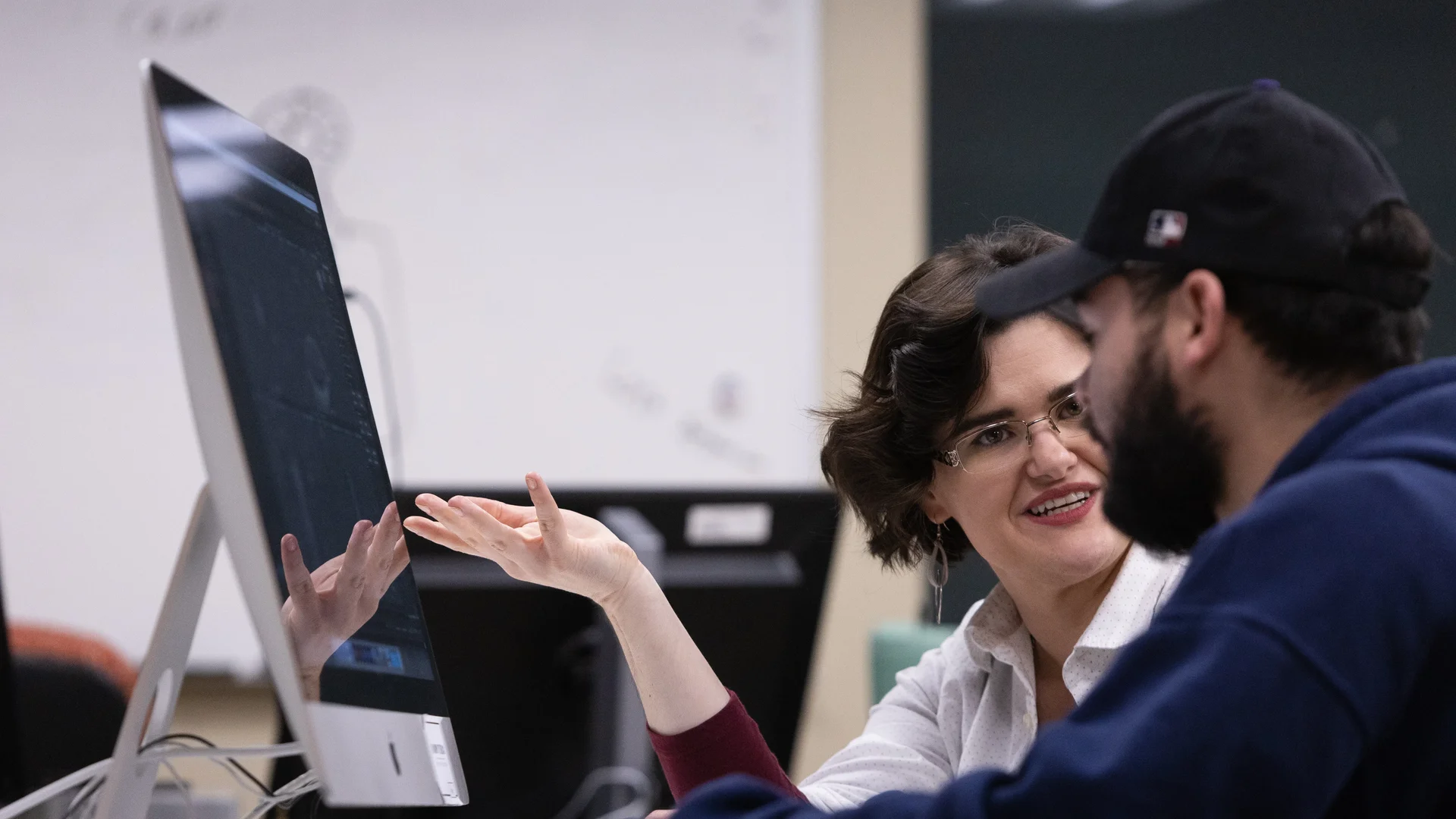 Houghton professor working with Applied Design & Visual Communication major in Mab lab.