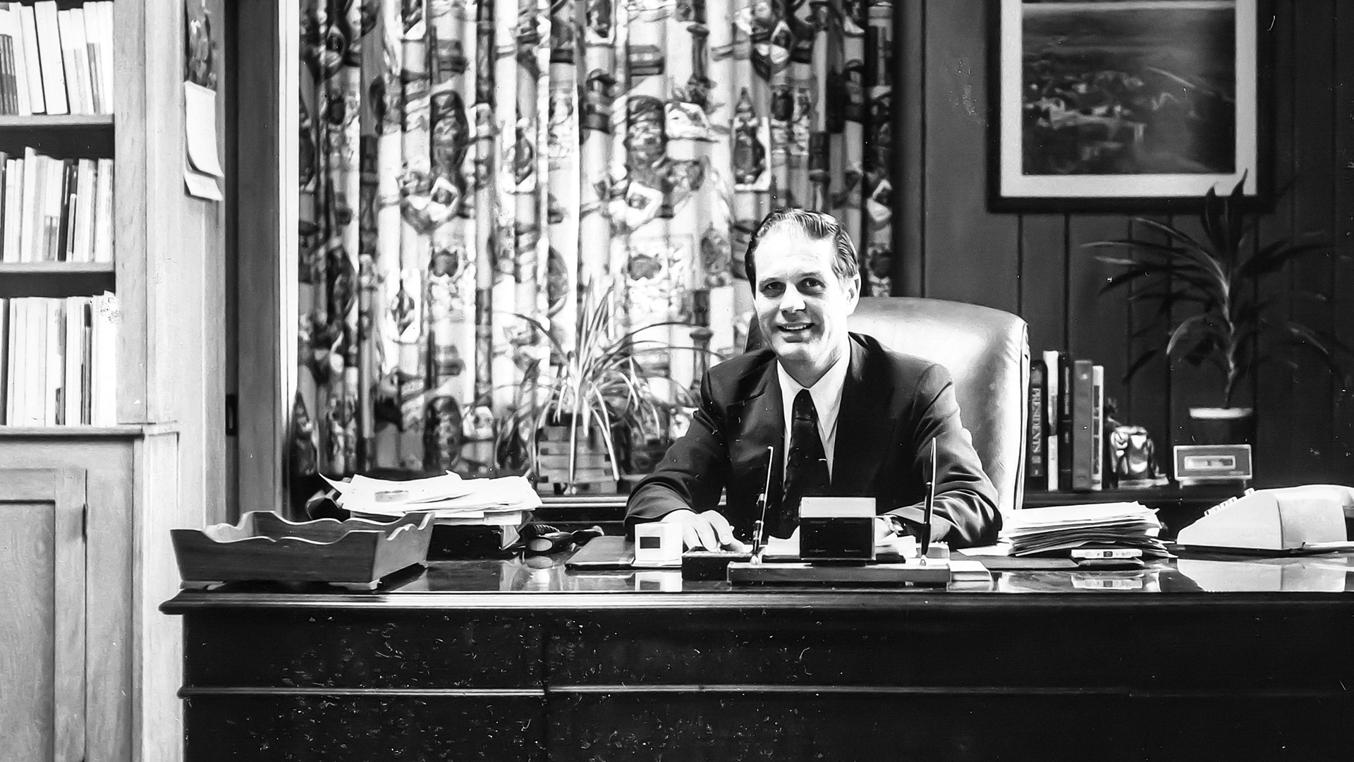 Houghton president emeritus Dan Chamberlain sitting at his desk.