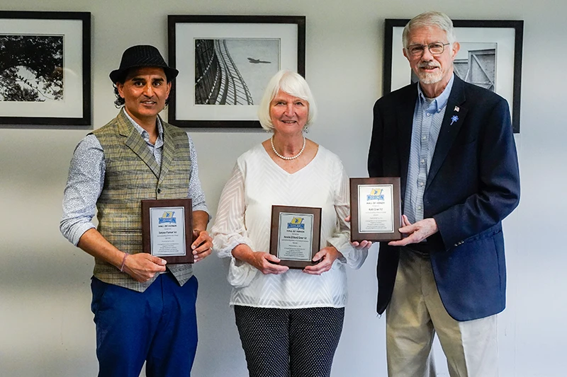 Houghton Athletics Hall of Honor inductees standing with plaques.