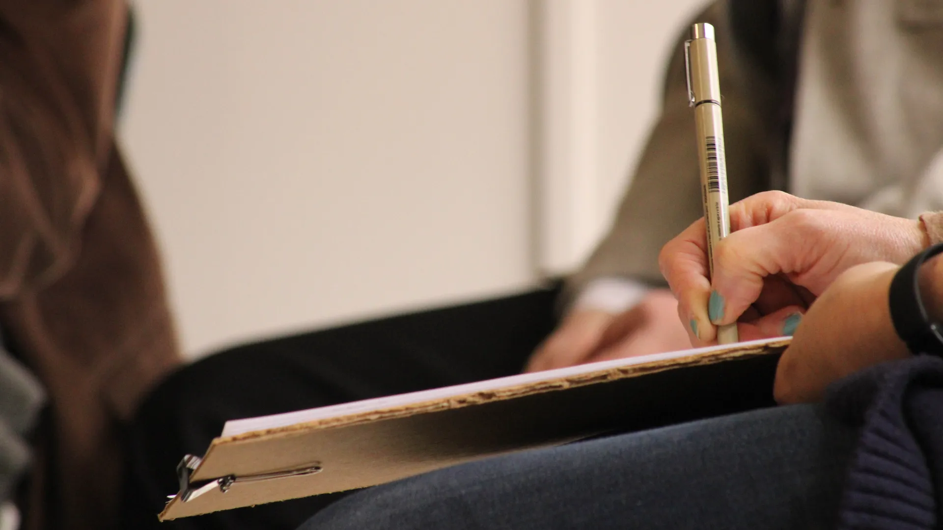 Houghton student writing on clipboard during Teacher Conference.