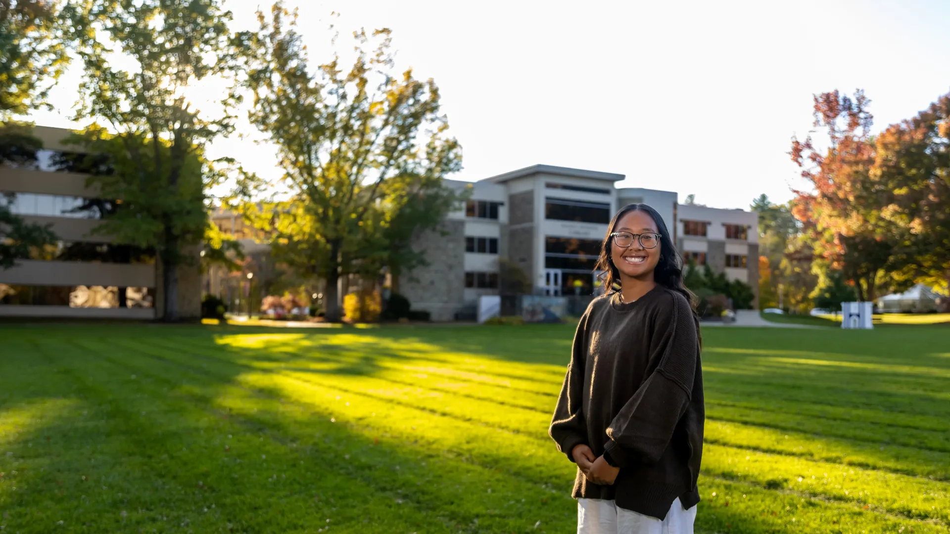 Houghton student MyaKay Bartman standing on quad during beautiful fall day.