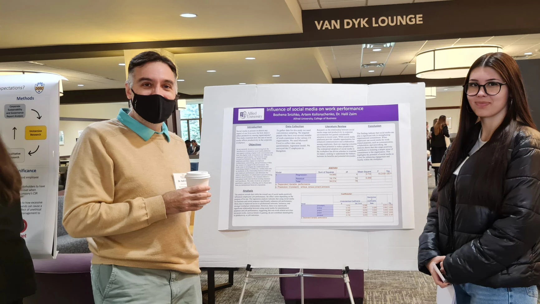 Student and professor standing by poster presentation at Penn-York Research Conference.