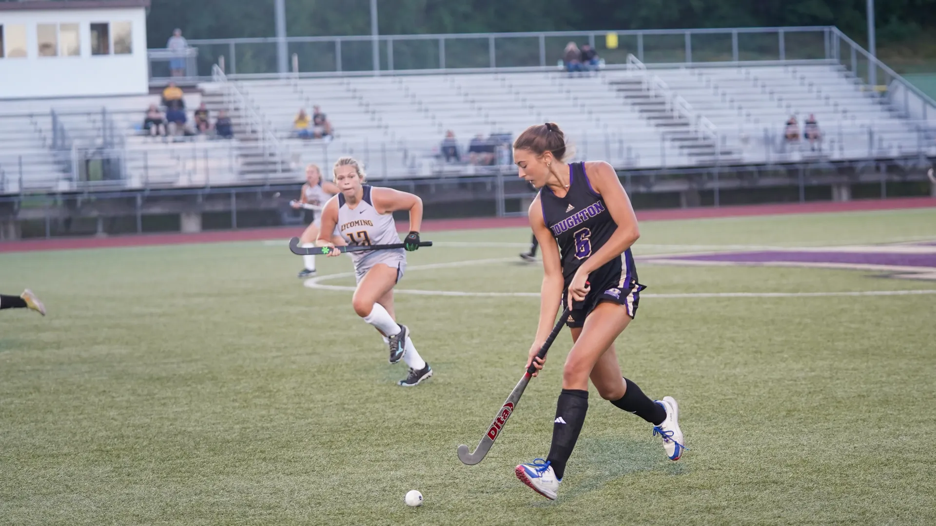 Houghton students playing field hockey
