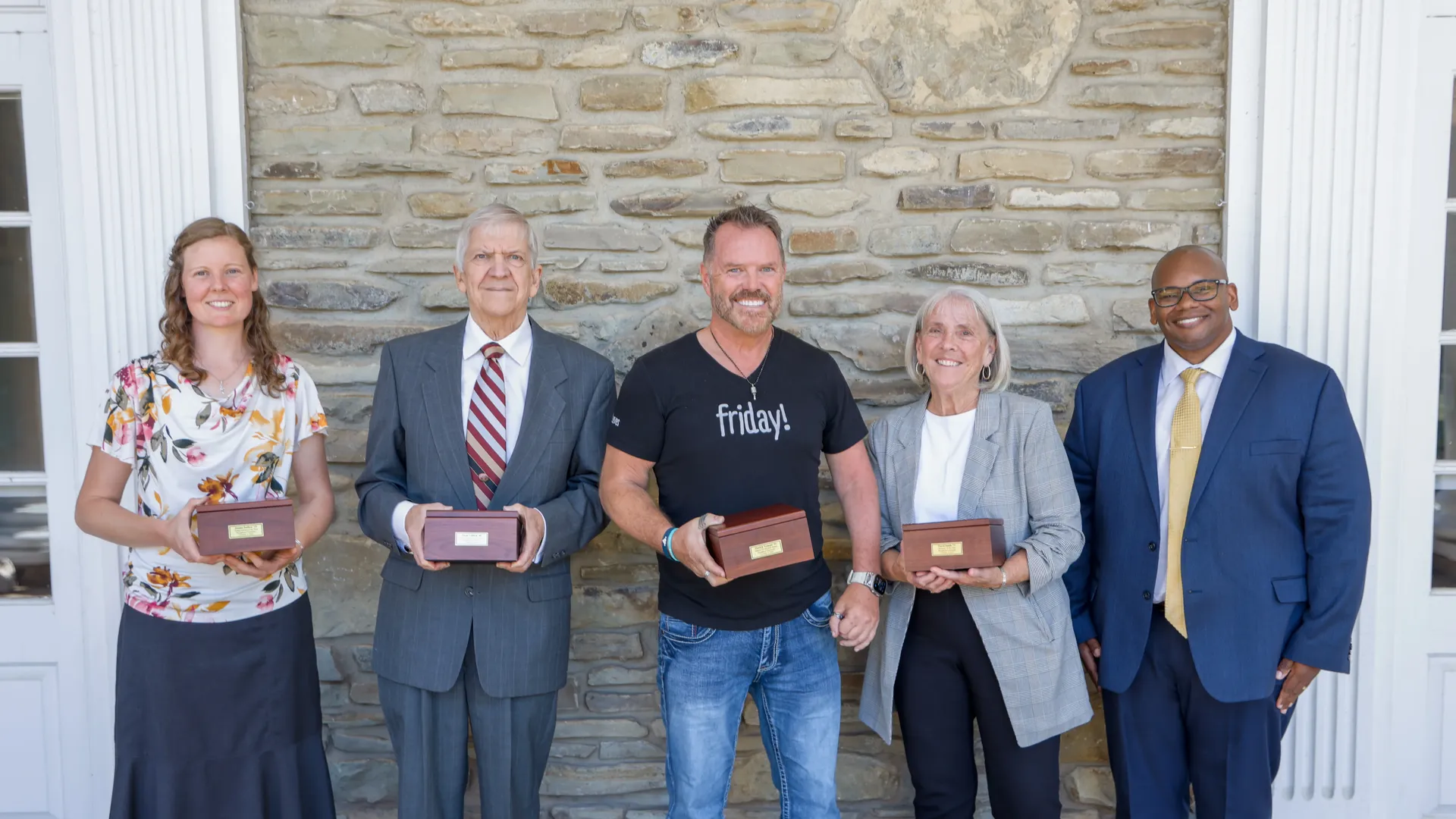 group outside chapel with awards